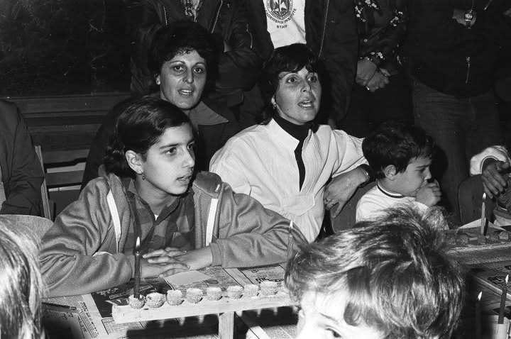 Community Celebrating Together The Jewish Holiday Of Hanukkah The Community Celebrating Together The Jewish Holiday Of Hanukkah - Kids Lighting Hanukkiyot and Singing Songs Together In Kibbutz Kfar Blum Dining Hall